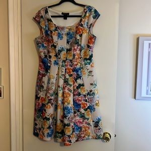 Neoprene cap sleeve bodycon dress with flare bottom.